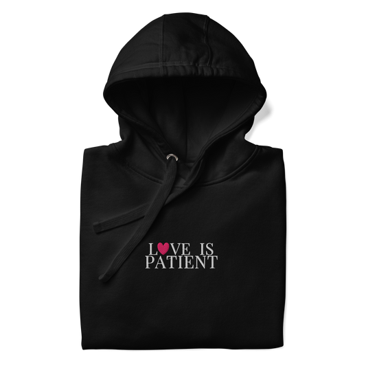 Black hoodie with 'LOVE IS PATIENT' text on a white background