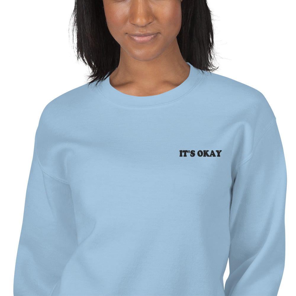 Model wearing the "It's Okay" crewneck sweatshirt in blue 