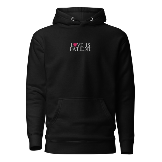 Black hoodie with 'LOVE IS PATIENT' text on a white background